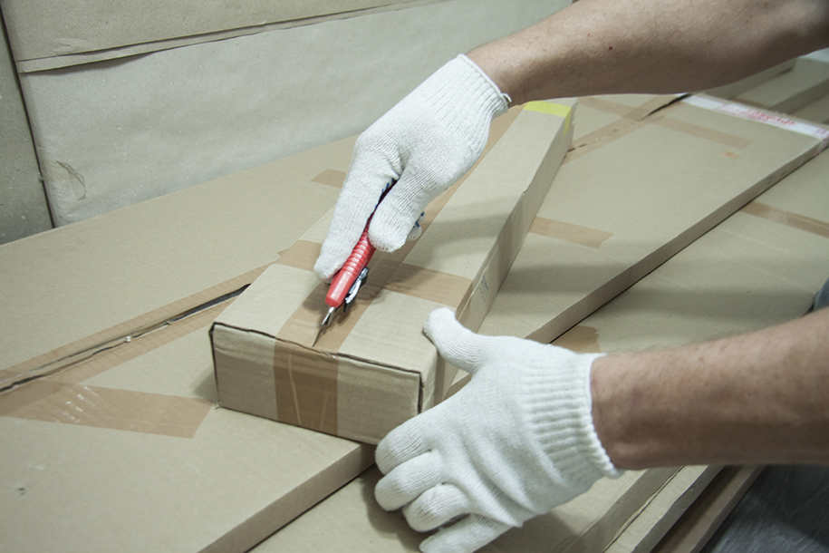 Box tape being cut with utililty knife