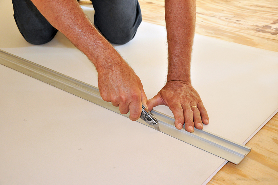 trade cutting plasterboard with utility knife